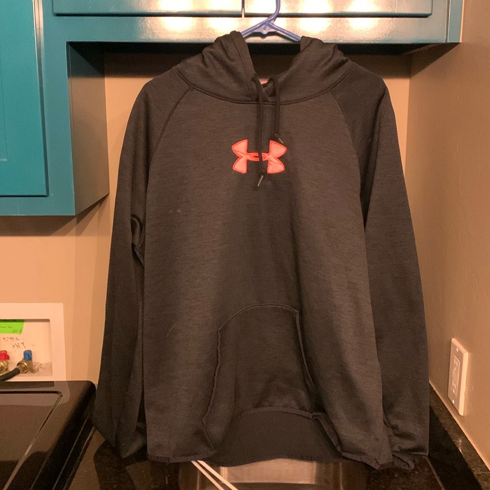 A XXL Under Armour blue sweatshirt with a pink woodland/camo pattern in hood.